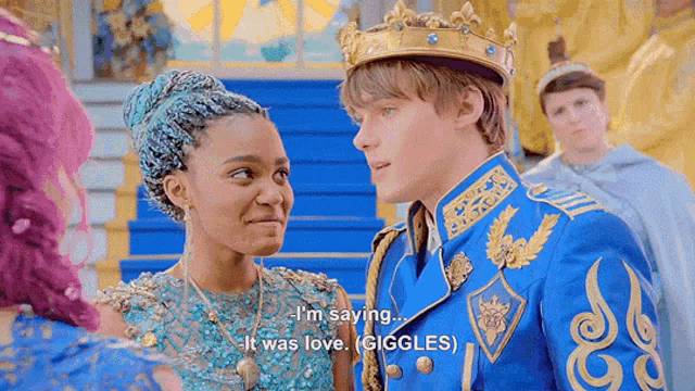 a man in a crown is talking to a woman in a blue dress .
