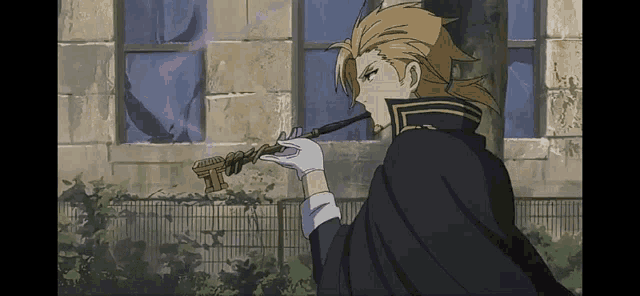 a man in a black cape smoking a pipe in front of a building