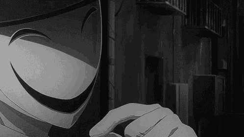 a black and white photo of a person wearing a mask with a smiley face .