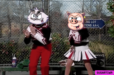 two cheerleaders are dancing in front of a sign that says parking lot ations aa-l