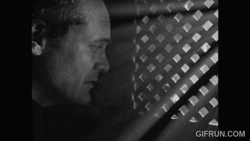 a black and white photo of a man with the website gifrun.com in the bottom right corner