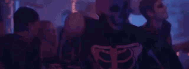 a blurry picture of a crowd of people dancing at a party in a club .