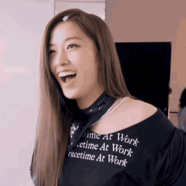 a woman wearing a black shirt that says facetime at work on it