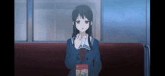 a girl in a school uniform is sitting on a train holding a box of cereal