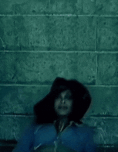 a woman in a blue jacket and black hat