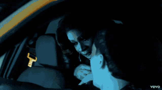 a man and a woman in a car with the word vevo in the corner