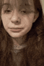 a close up of a woman 's face with long hair