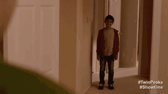 a boy standing in a hallway with #twinpeaks #showtime on the bottom right