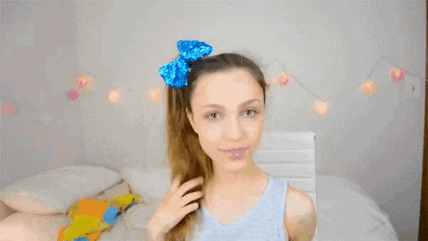 a girl with a blue bow in her hair has the words totes and aders above her