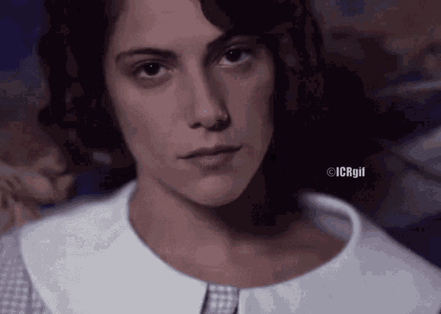 a close up of a woman 's face with icrgil written on the bottom right