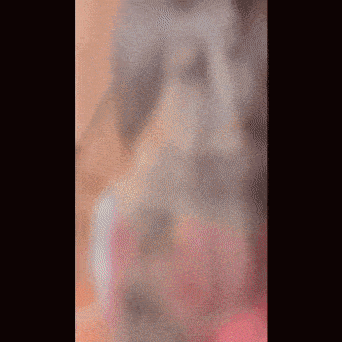 a blurry picture of a girl wearing a pink shirt and hijab .