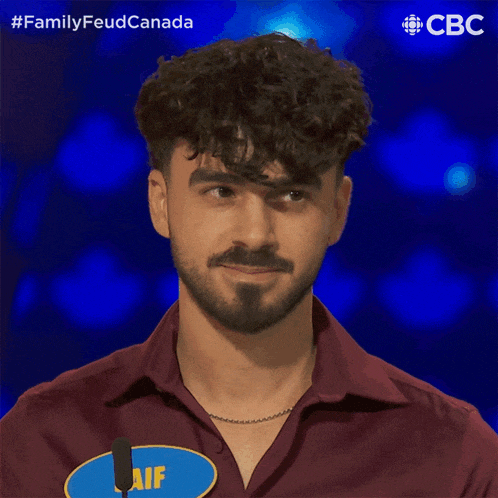 a man with curly hair and a beard is wearing a shirt that says " aif "