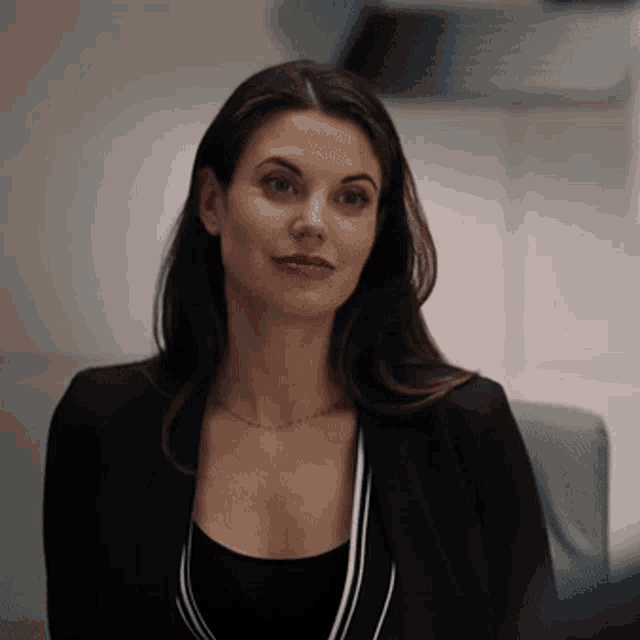 a woman wearing a black jacket and a black top