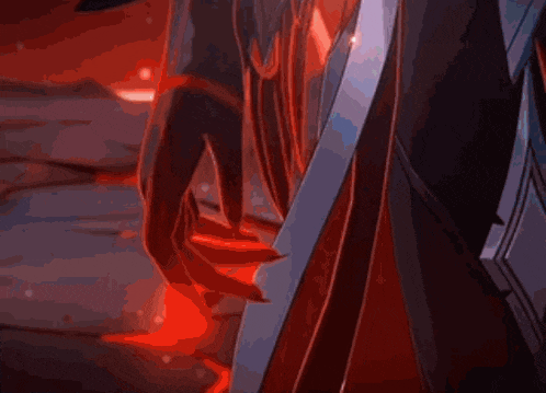 a close up of a person 's hand holding a sword in a dark room .