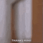 a blurry picture of a man peeking out from behind a door and saying `` thanks mimi '' .