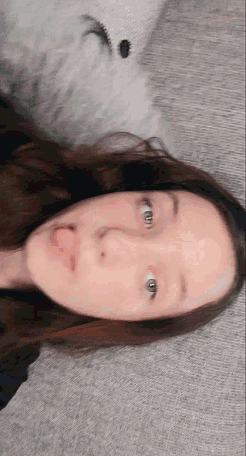 a girl laying on the floor with her tongue hanging out