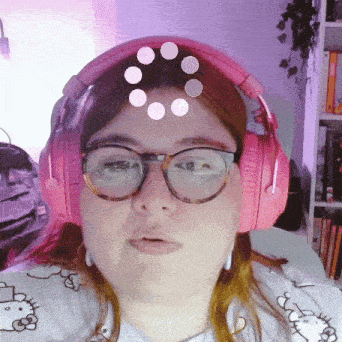 a woman wearing glasses and pink headphones with a hello kitty shirt