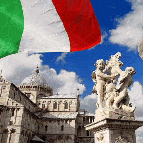 a statue in front of a building with a flag flying in the background