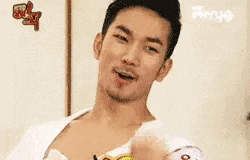 a man with a beard is making a funny face while holding something in his hands .