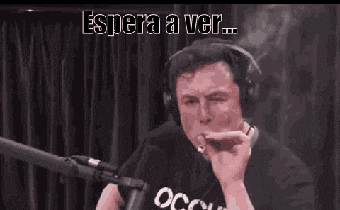 a man wearing headphones is smoking a cigarette in front of a microphone .