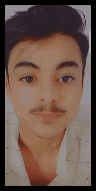 a close up of a young man 's face with a beard