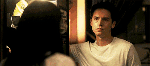 a man and a woman are looking at each other in a room .