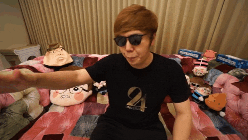 a man wearing sunglasses and a shirt that says 24 on it