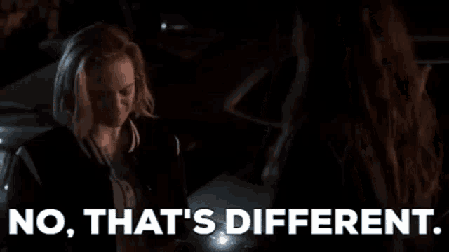 two women are standing next to each other in a dark room .