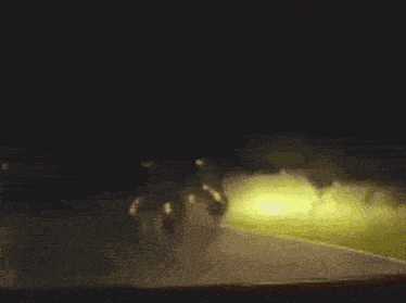 a group of people are walking in the dark