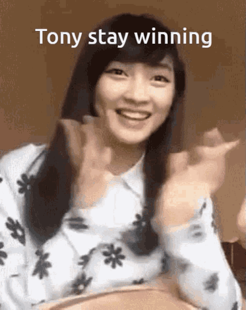 a girl is clapping her hands and smiling with the words tony stay winning written above her