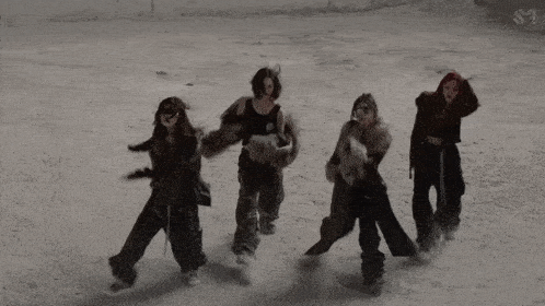 a group of women are dancing in the snow with the letters s1 on the bottom