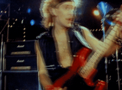 a man is playing a red electric guitar in front of a marshall amplifier