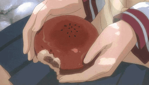 a person is holding a red item with a bite taken out of it