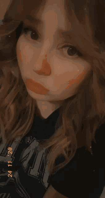 a close up of a woman 's face with the date 24/11/20