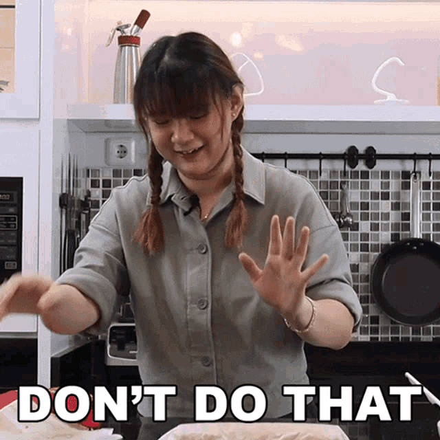 a woman in a kitchen with the words " do n't do that "