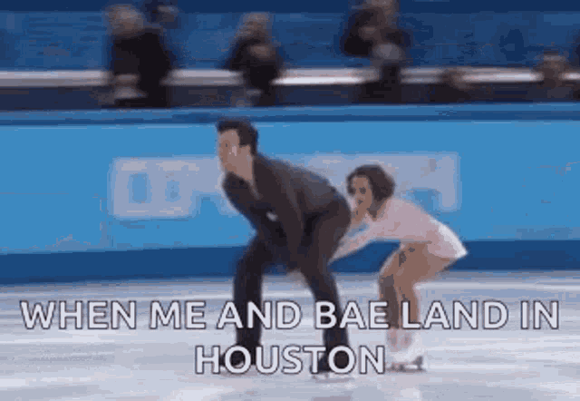 a man and a woman are ice skating on a rink and the man is holding the woman 's hand .
