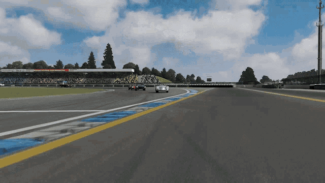 a race car is driving down a track with a sign that says motorsports
