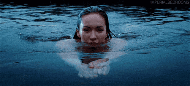 a woman is swimming in a body of water that says imperial bedrooms on the bottom