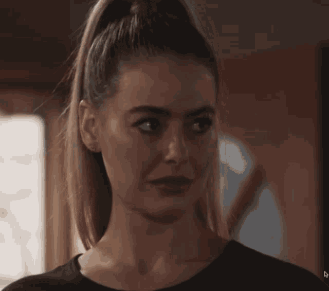 a close up of a woman 's face with a black shirt on