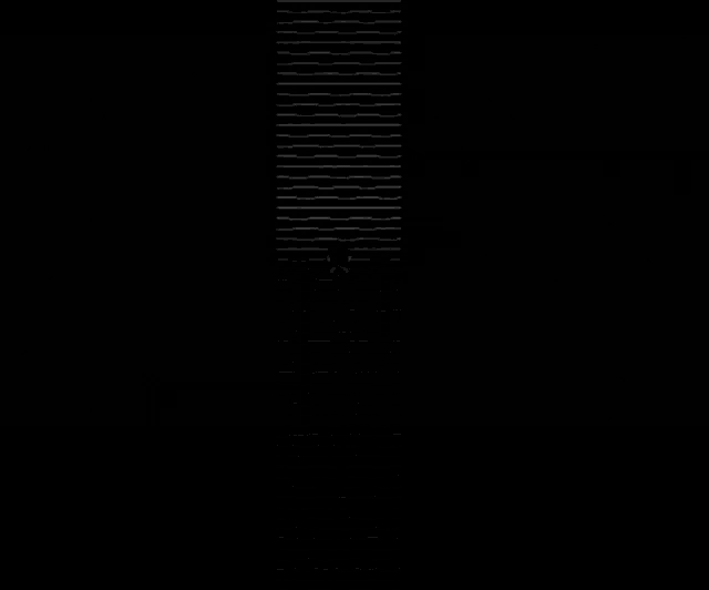 a black and white image of a person standing in front of a wall with a picture on it .