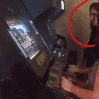 a woman is playing a video game with a red circle around her