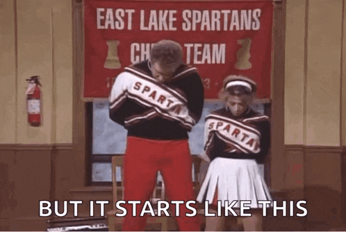 a man and a woman are standing in front of a sign that says east lake spartans cheer team but it starts like this