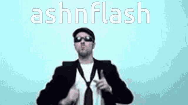 a man in a suit and tie is dancing with the words ashnflash behind him
