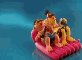 a couple of cartoon characters are laying on a pink raft