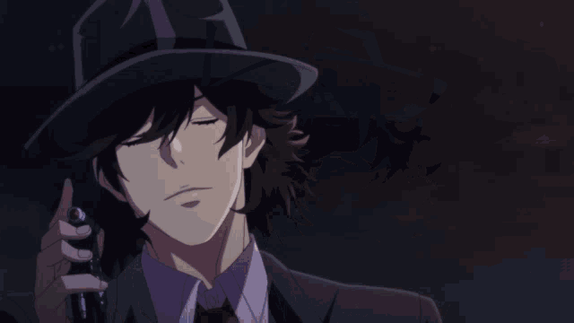 a man in a suit and hat is holding a gun with the letter t on it