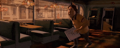 a man in a diner is holding a sign that says ' pizza hut ' on it