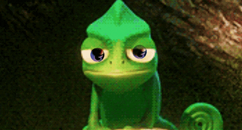 a green lizard with blue eyes is sitting on a rock looking at the camera