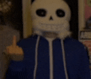 a person wearing a skeleton mask and a blue jacket is giving the middle finger .