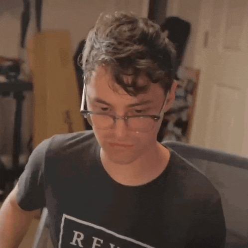 a man wearing glasses and a t-shirt that says rfi