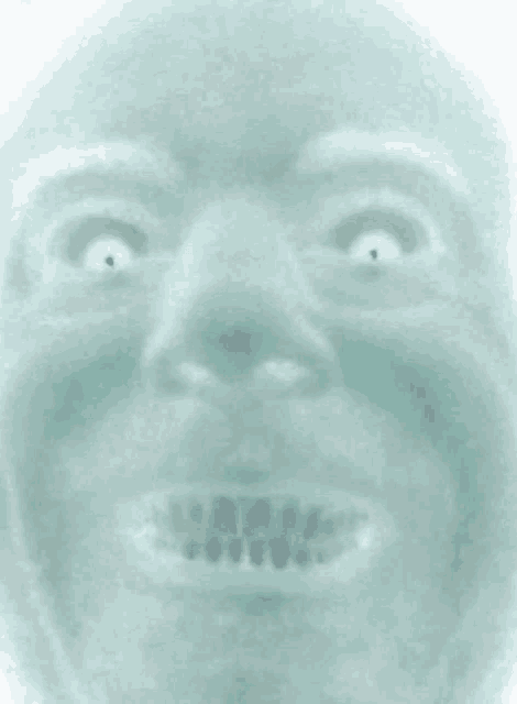 a close up of a person 's face with white eyes and a smile